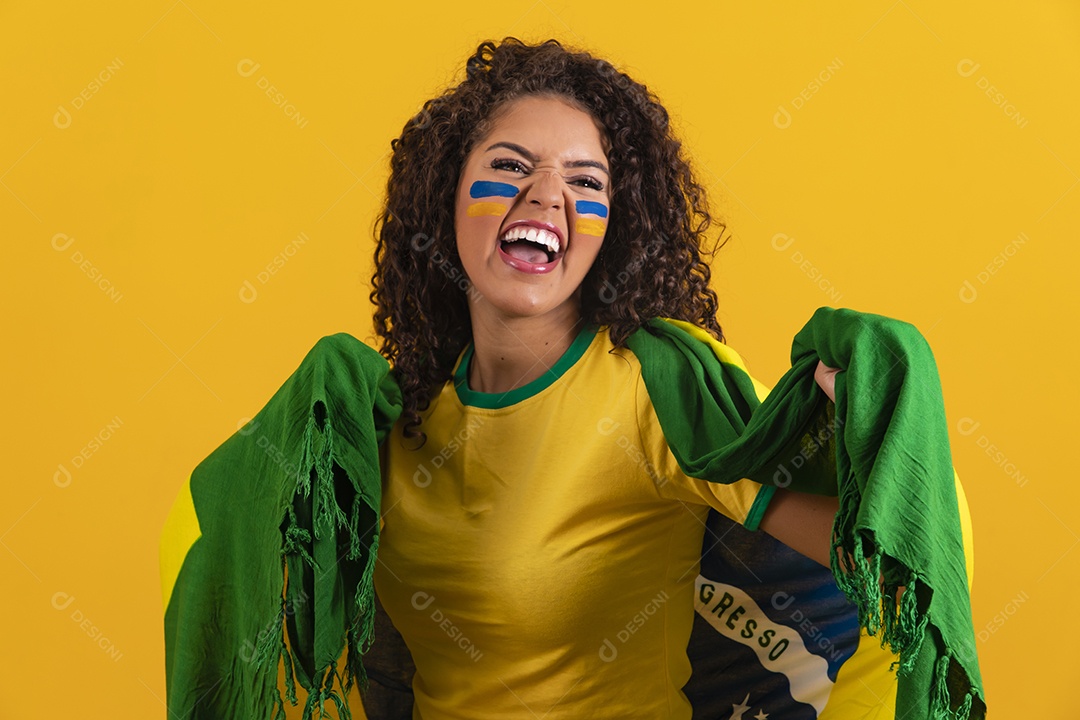 Linda mulher jovem morena segurando bandeira do brasil cabelo afro sobre fundo isolado amarelo
