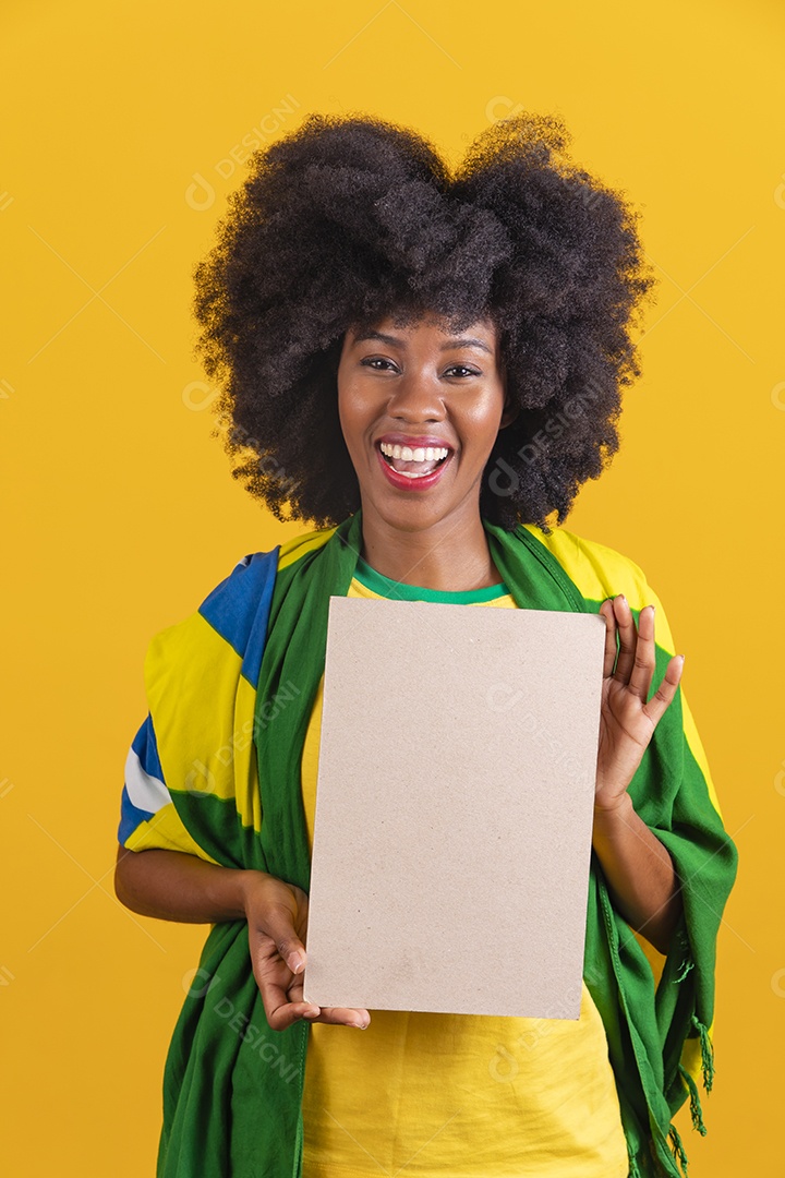 Linda mulher jovem morena segurando bandeira do brasil cabelo afro sobre fundo isolado amarelo