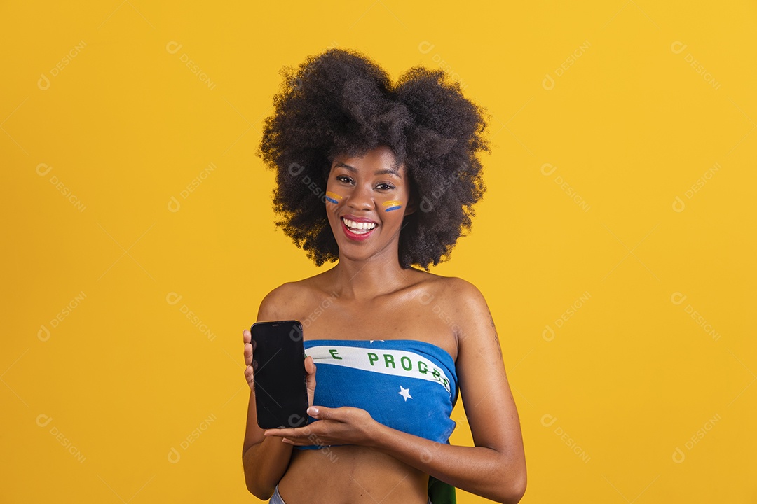 Black woman wearing flag of Brazil holding a cellphone smartphone