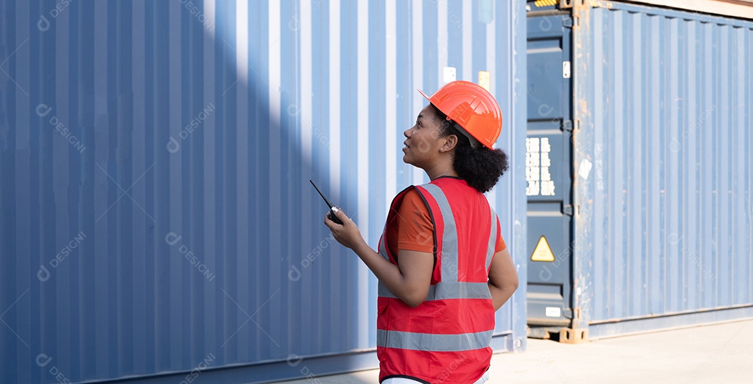 Capataz de mulher segurando o controle de walkie talkie carregando os recipientes