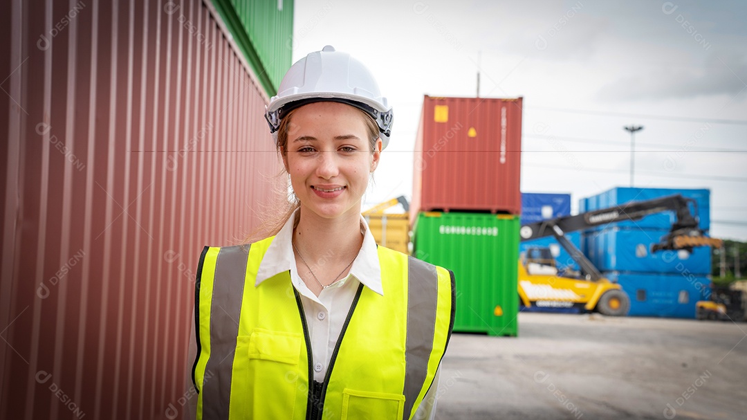 Mulher capataz sorri ao lado do contêiner de carga no armazém, gerente no capacete branco Supervisora