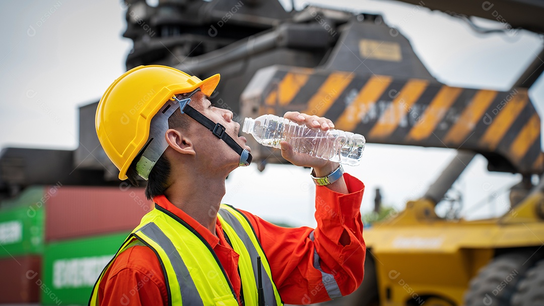 Foreman or worker is drinking a bottle of water after finishing.