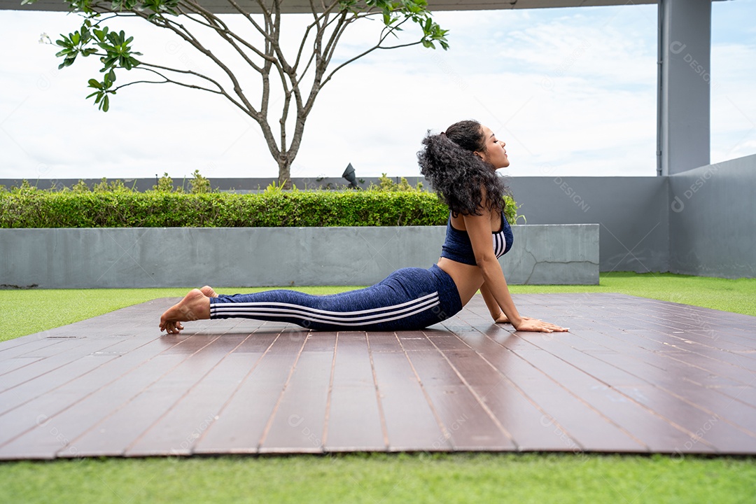 Yoga medita contra arranha-céus modernos. Moça que passa o tempo lá fora no condomínio da cobertura fazendo exercícios de ioga.