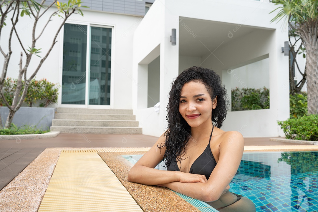 Woman in a bikini in the pool Tanned and fit swimming pool.