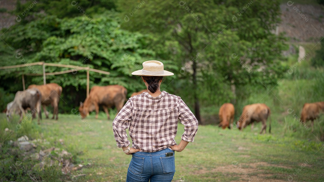 Mulher trabalhadora posando em uma fazenda de gado leiteiro fora do rancho a