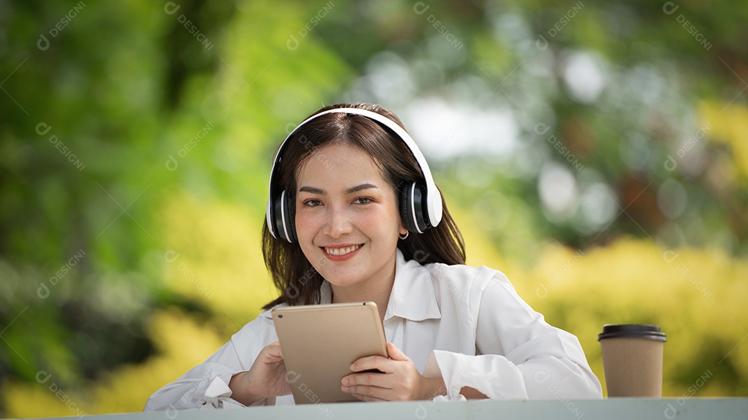 Menina linda jovem de camisa bege posando na cidade verde.