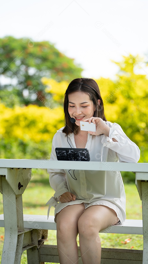 Garota do sorriso do cliente comprando on-line ou trabalhando on-line com um telefone inteligente e cartão de crédito.
