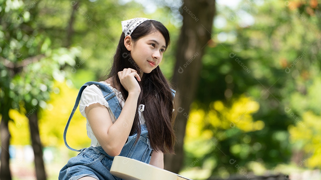 Retrato de foto sorrindo menina no parque verde da cidade.