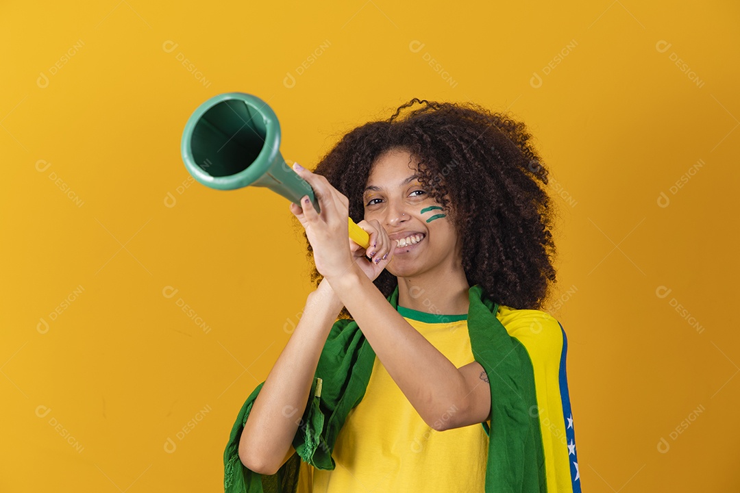 Afro-Brazilian woman wearing Brazil t-shirt with cheerleading accessory