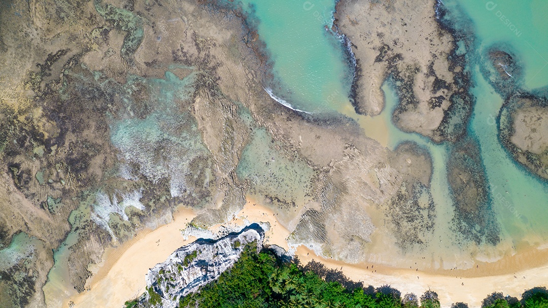 Vista aérea da Praia do Espelho, Porto Seguro, Bahia, Brasil. Piscinas naturais no mar, falésias e águas esverdeadas.