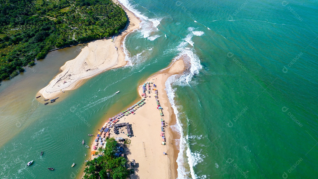 Aerial view of Caraiva beach, Porto Seguro, Bahia, Brazil. Colorful beach tents, sea and river.