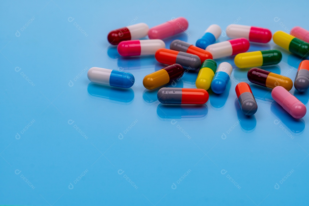 Acima, veja as cápsulas coloridas sobre fundo azul. prescrições