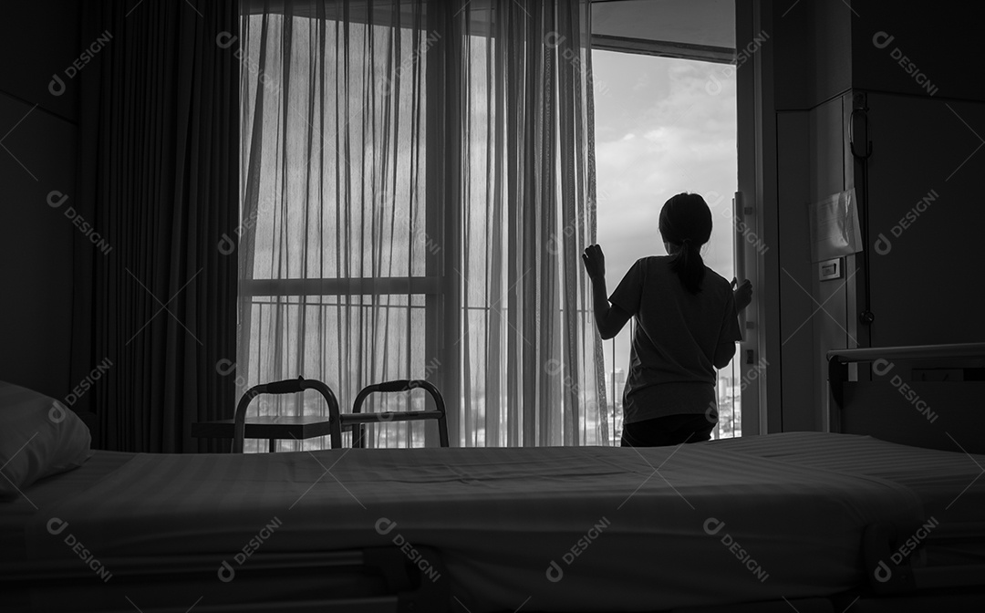 Mulher asiática adulta triste olhando pela janela e pensando.