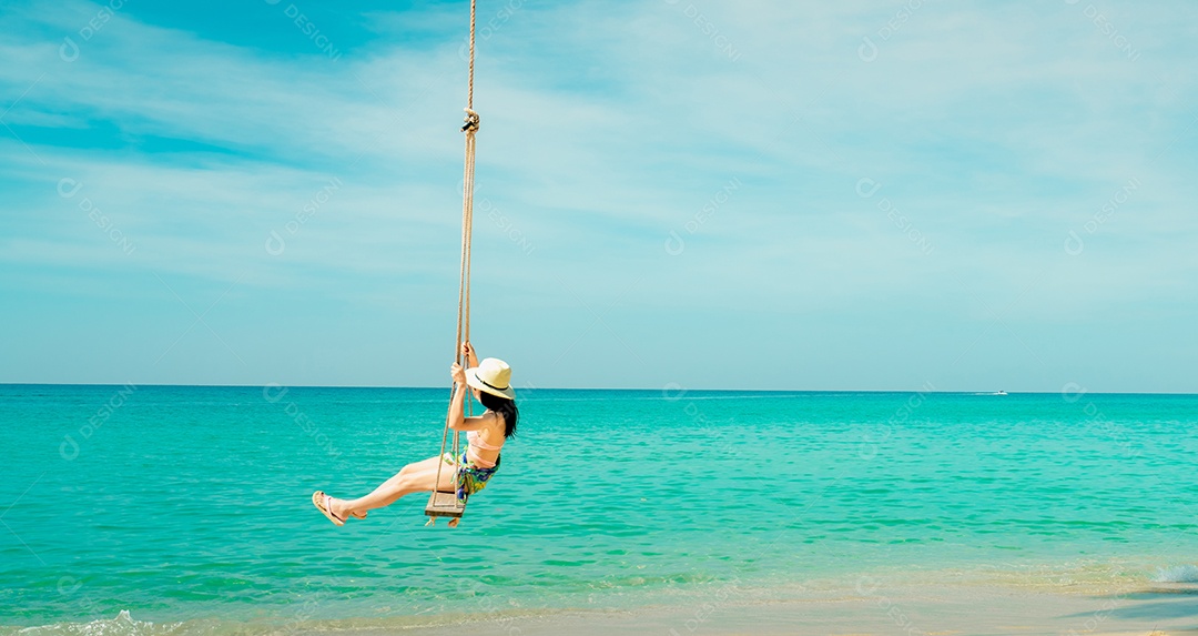 Feliz jovem asiática de maiô rosa e chapéu de palha