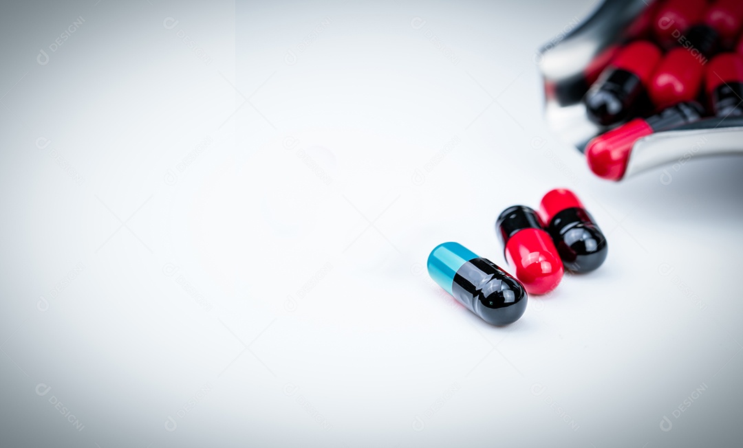 Pílula de cápsula verde-azulada de foco seletivo e bandeja de drogas com vermelho