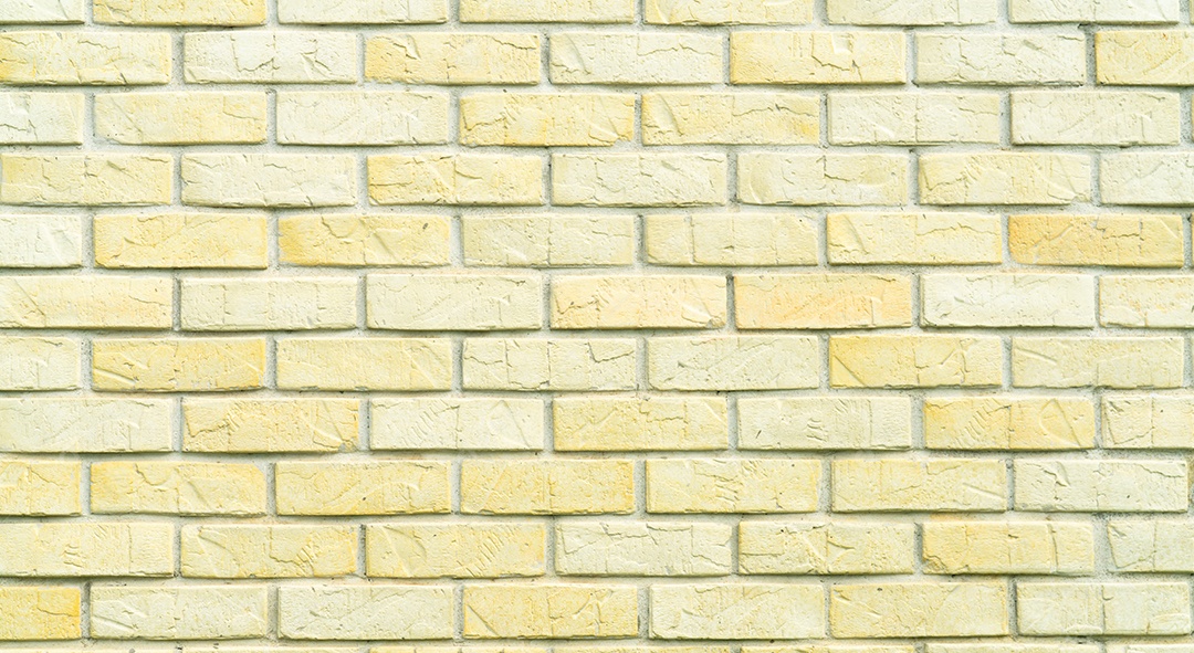 Fundo amarelo e branco da textura da parede de tijolo com espaço