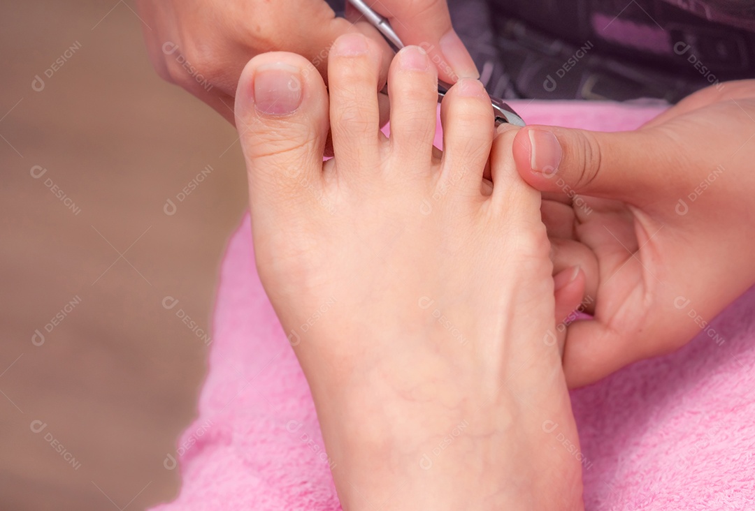 Mulher recebendo serviço de pedicure de unha por pedicure profissional