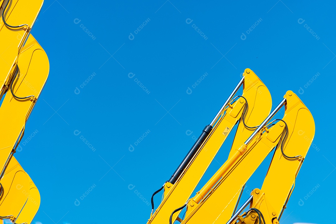 Pistão hidráulico closeup de retroescavadeira amarela contra o céu azul.