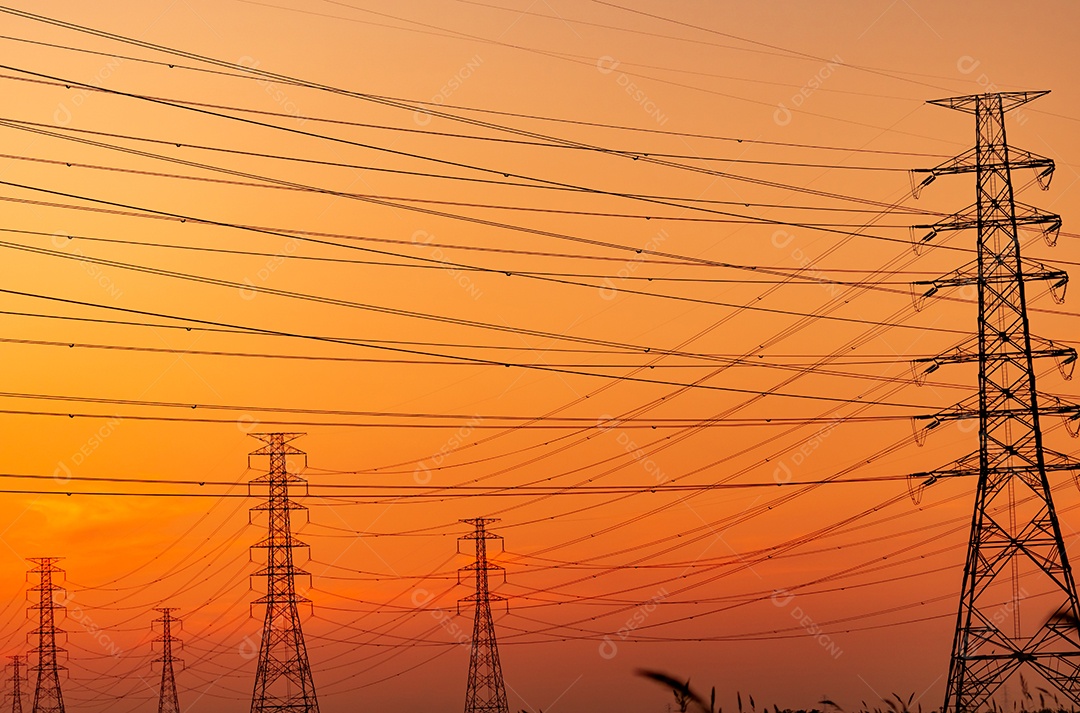 Pilão elétrico de alta tensão e fio elétrico com céu pôr do sol.