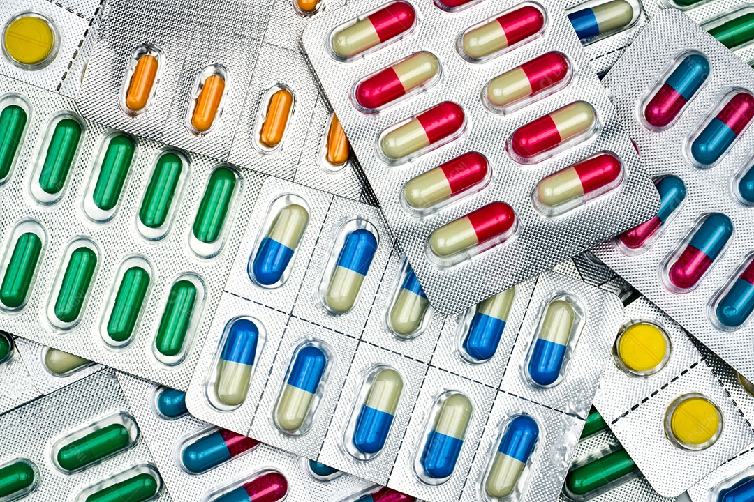 Visão superior de comprimidos coloridos e cápsulas em blister