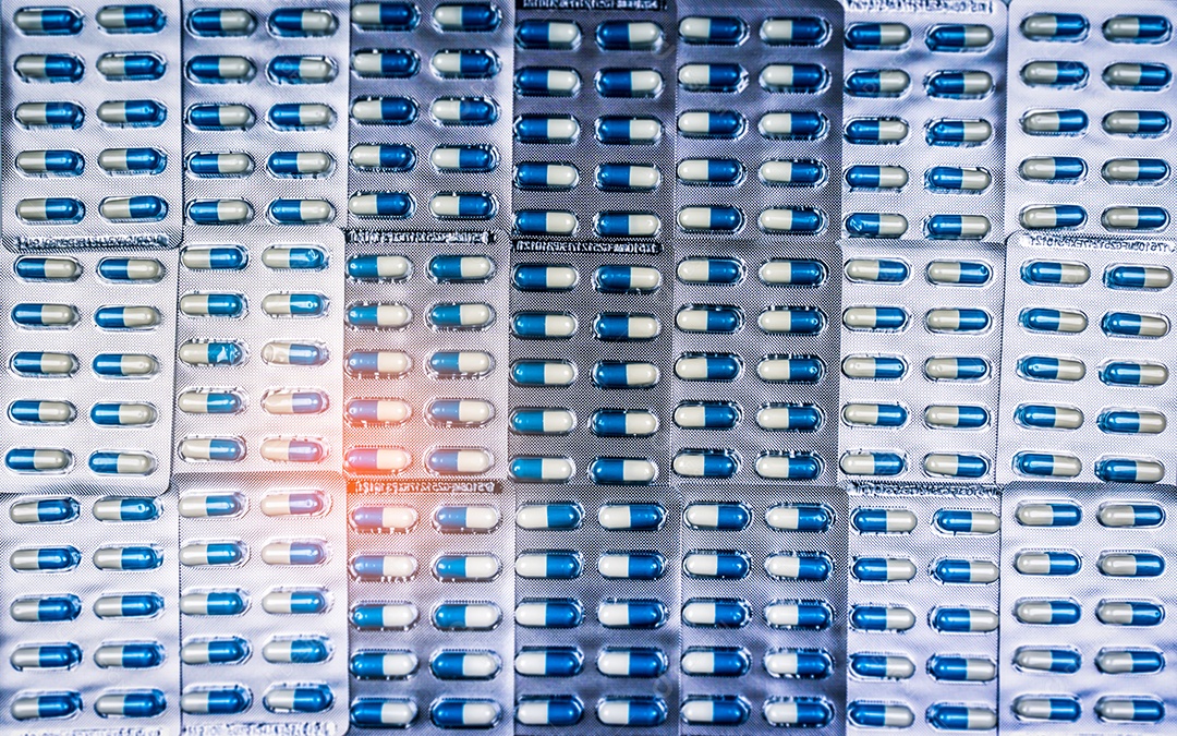 Comprimidos de cápsulas azuis e brancas em blister. Indústria Farmacêutica