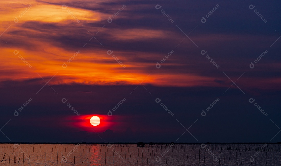 Belo pôr do sol sobre o mar. Céu vermelho escuro e pôr do sol laranja