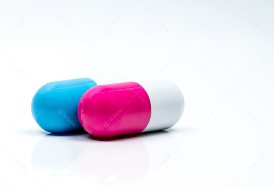 Dois comprimidos cápsula isolados no fundo branco.