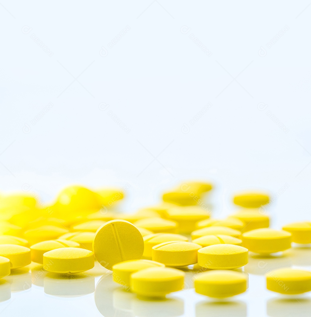 Comprimidos de comprimidos amarelos isolados no fundo branco com espaço de cópia