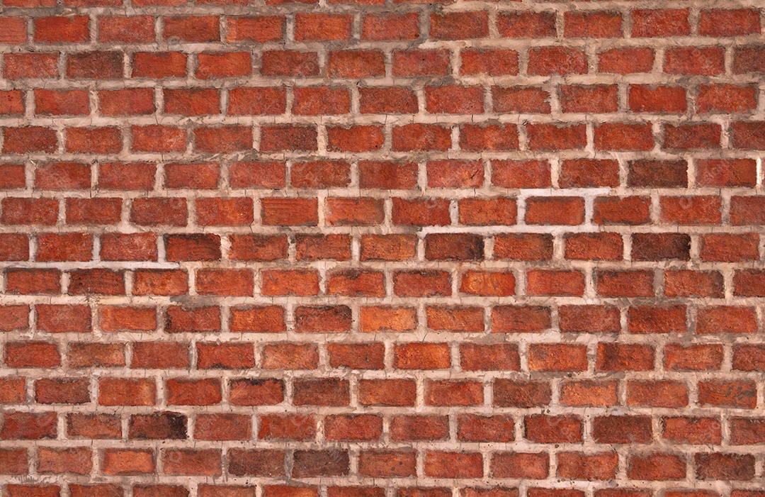 Parede de tijolos laranja feita de tijolo e cimento. Textura  da parede de tijolos