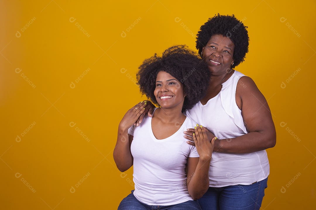 Mulheres negras mãe e filha vestidas com blusa branca com gestos de carinho