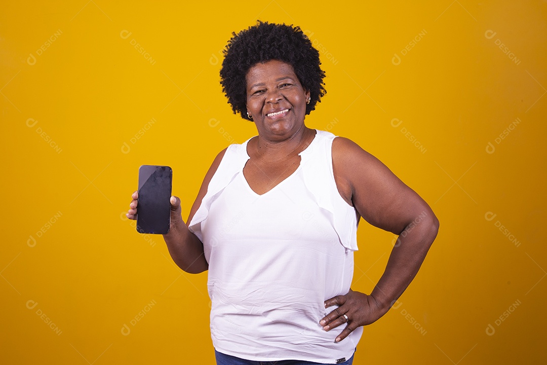 Mulher de meia idade usando camiseta branca segurando um smartphone celular