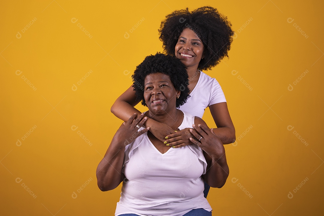 Filha abraçando sua mãe cabelos afro família
