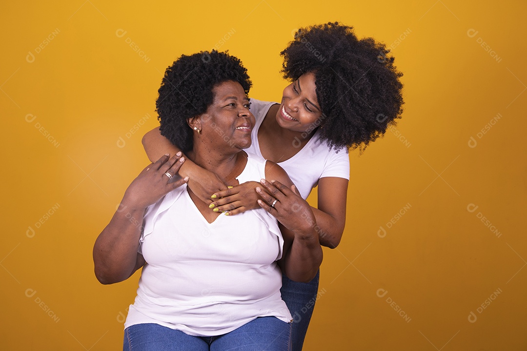 Filha abraçando sua mãe cabelos afro família