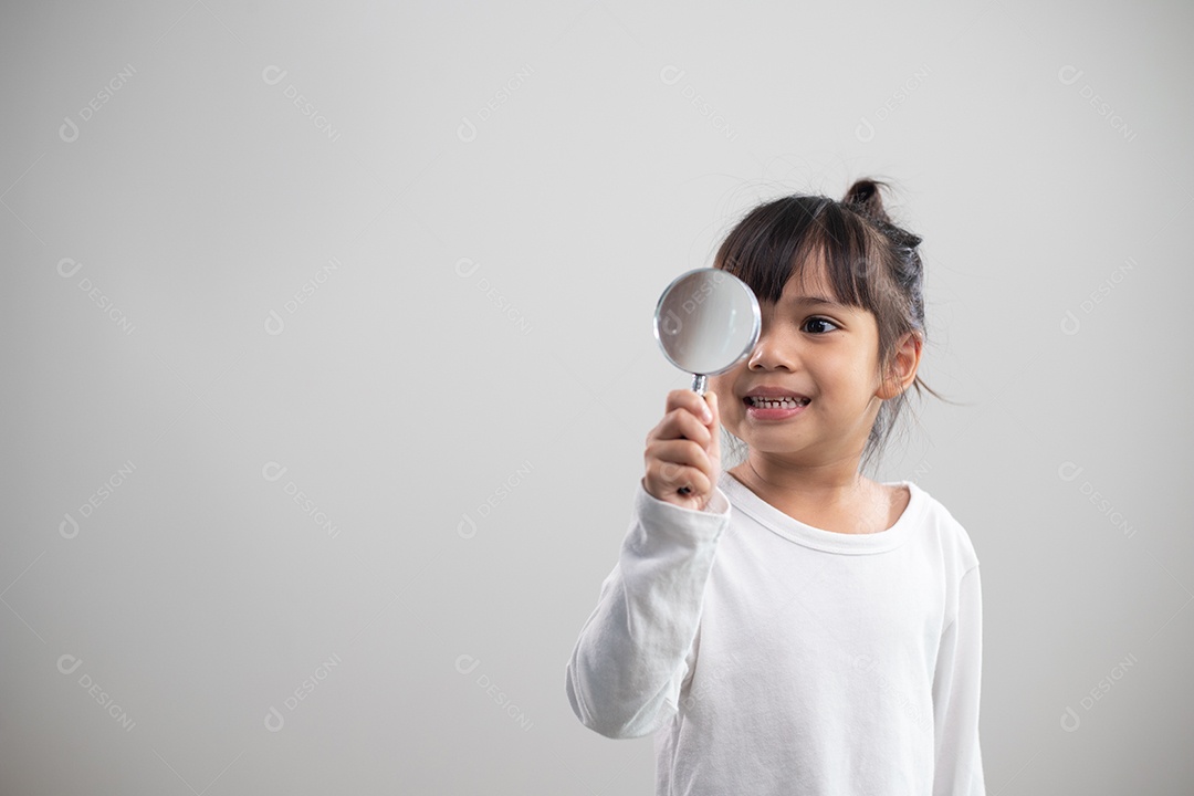 girl looking through a magnifying glass