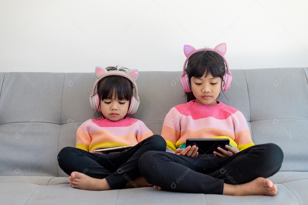 Asian sibling girl browsing social media and playing games