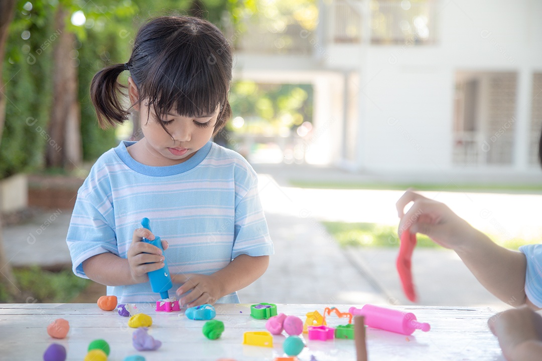 Criança asiática brincam com formas de moldagem de argila, aprendendo brincando