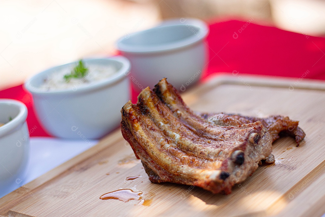 Carne assada costela sobre uma tabua de madeira