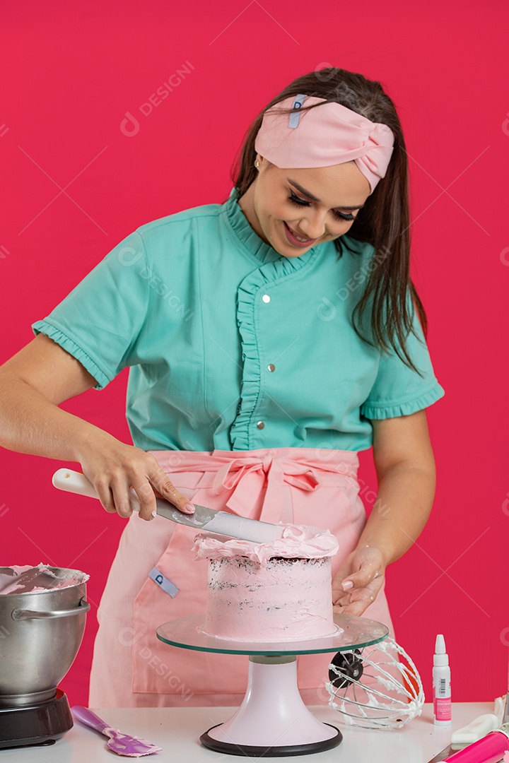 Linda mulher preparando bolo confeitado