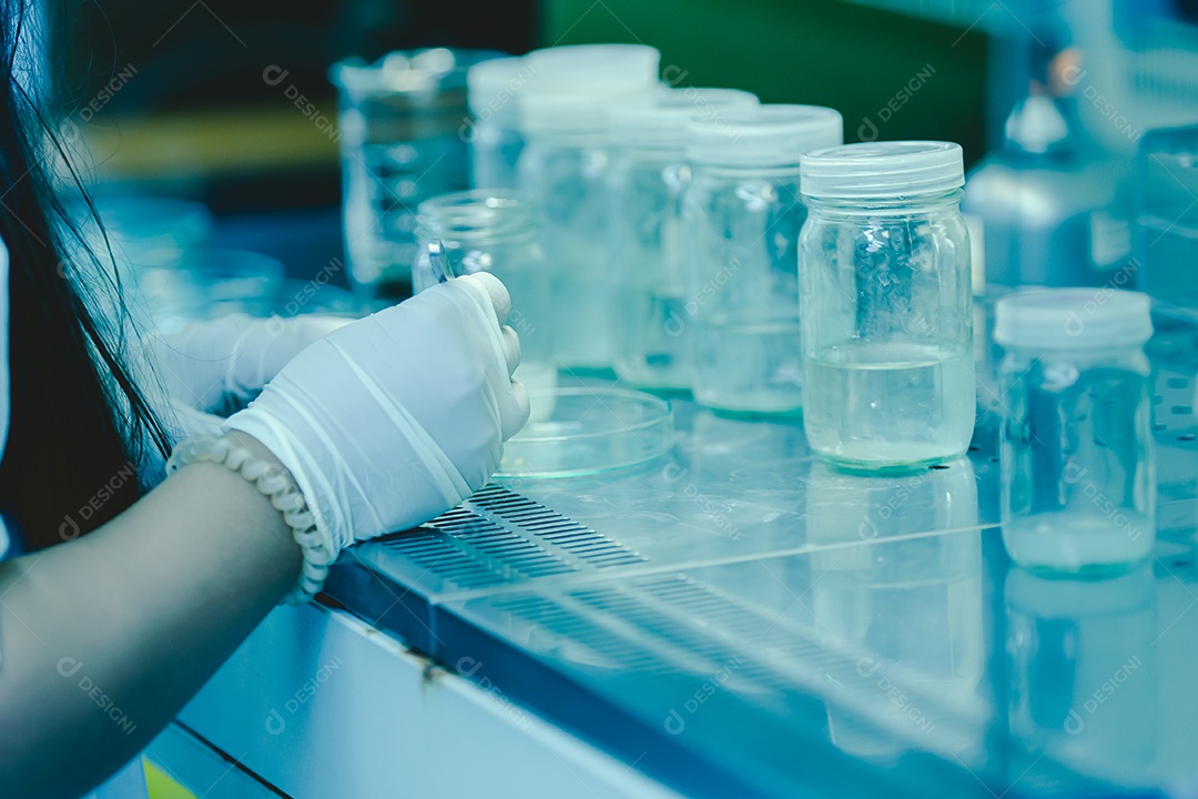 Laboratory technician in protective glasses and microscope gloves in the laboratory.