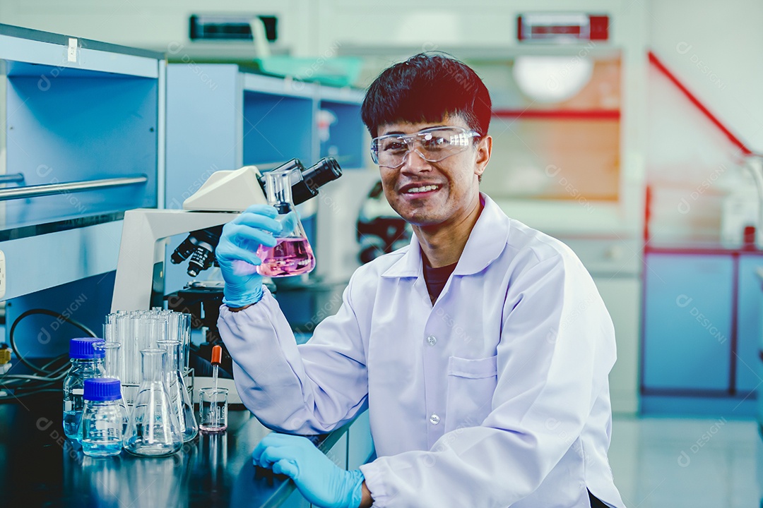Laboratory technician in protective glasses and microscope gloves in the laboratory.