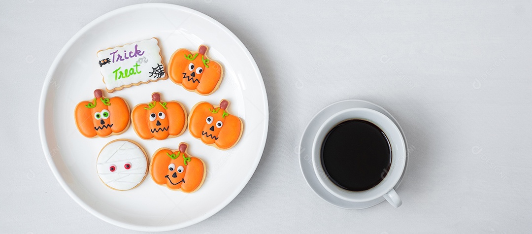 Cup of hot coffee with funny Halloween cookies. Happy Halloween