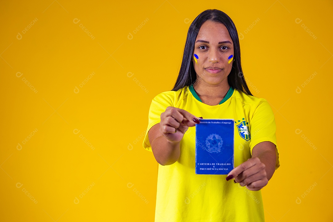 Beautiful female supporter of the Brazilian national team holding a work card