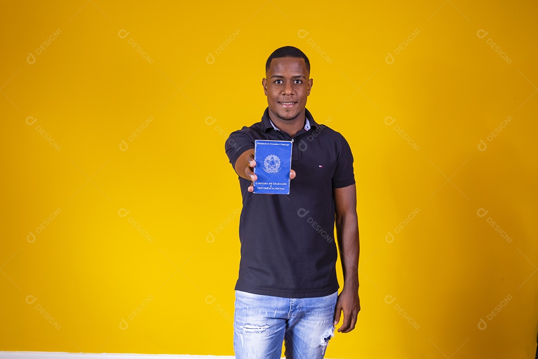 Homem jovem moreno sorridente e alegre segurando carteira de trabalho