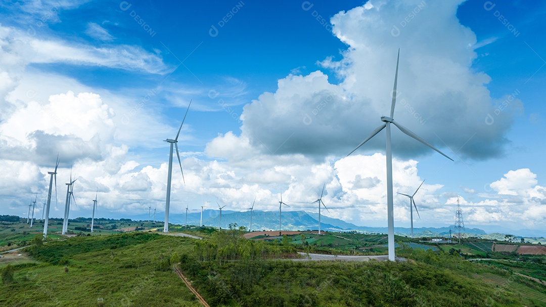 Turbina eólica com céu azul e fundo nublado.