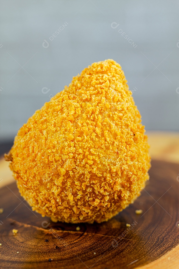 Imagem de coxinhas sobre taboa de madeira.