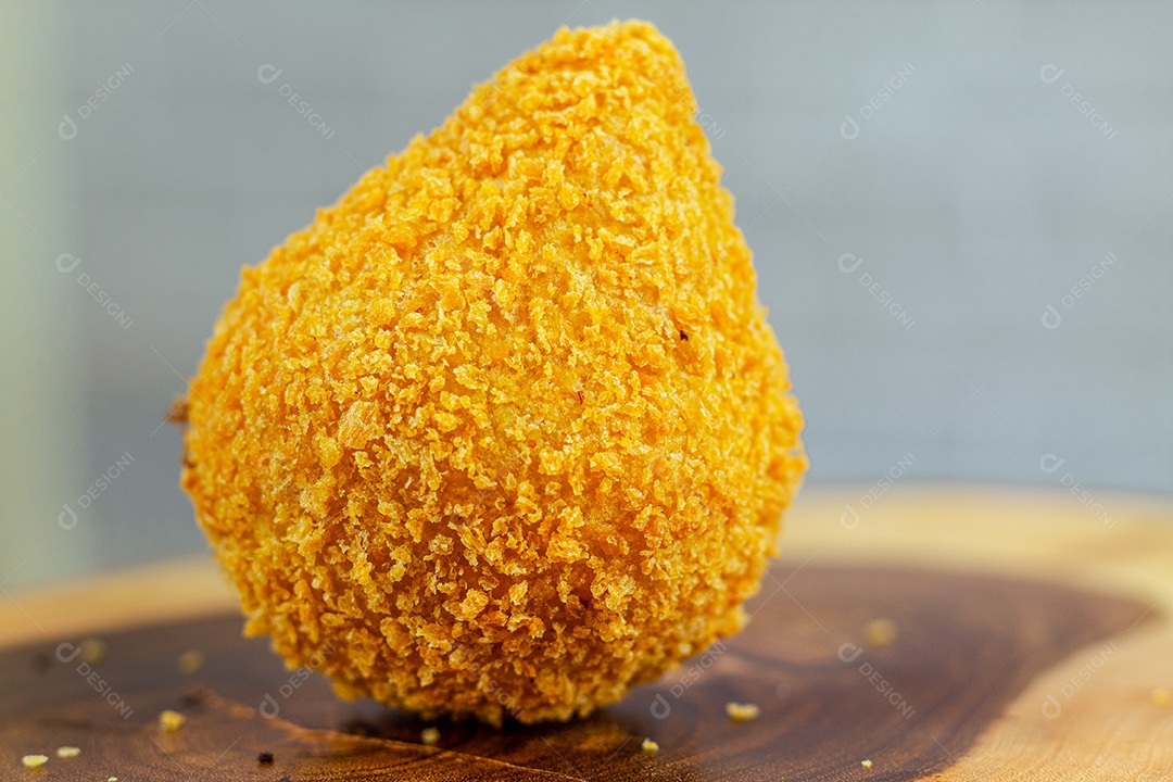 Imagem de coxinhas sobre taboa de madeira.