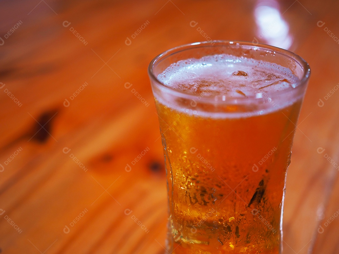 Glass of beer on a wooden background.