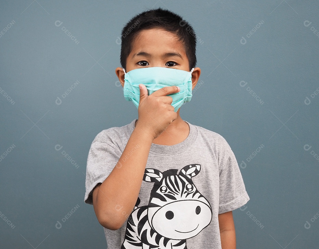 Um menino usando uma máscara protetora enquanto cobria a mão.
