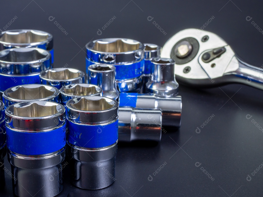 Conjunto de chave de bloco e chave de catraca em um fundo preto.