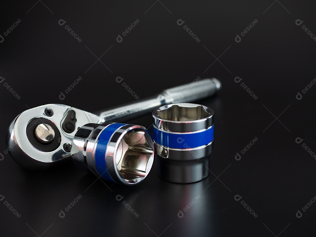 Conjunto de chave de bloco e chave de catraca em um fundo preto.